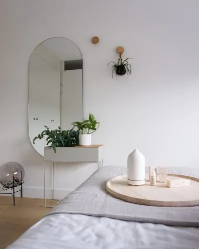 Photo by volant a bedroom with a bed, mirror and plant