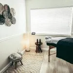 Photo by Cherosi white and black round table near white wall